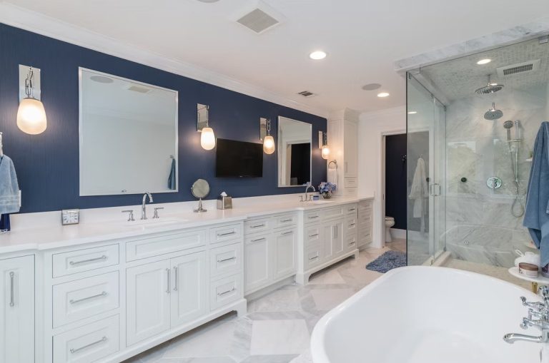 Luxury master bathroom with a walk-in glass shower, marble-tiled walls, and a built-in stone bench.
