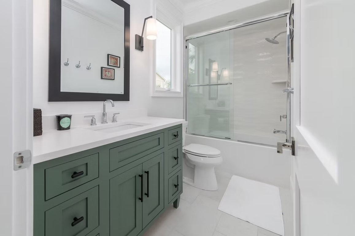 High-end bathroom vanity featuring double sinks, polished marble countertops, and custom dark wood cabinetry with ornate detailing.