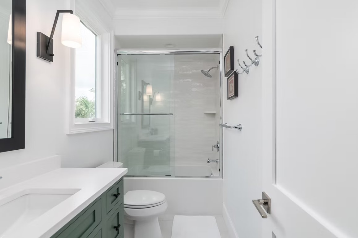 Luxury master bathroom featuring a large freestanding soaking tub, a seamless glass walk-in shower, and elegant marble tiling throughout.