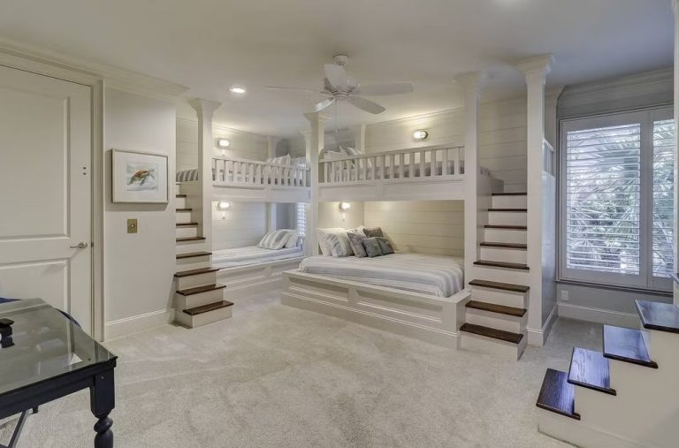 Bunk room with four built-in bunks, wooden stairs, and window seat