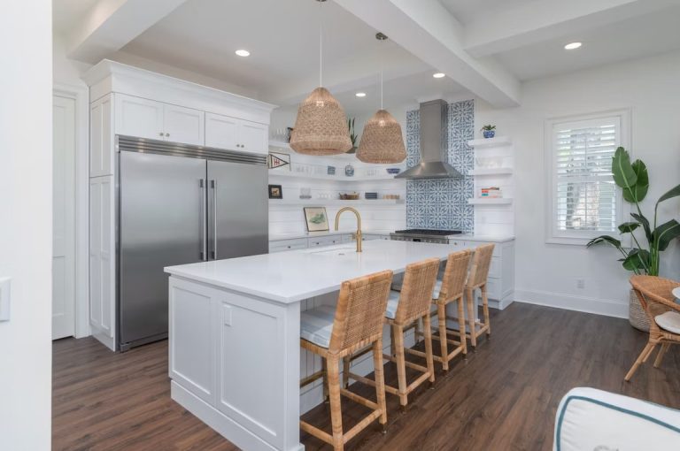 Luxury custom kitchen interior featuring high-end cabinetry, a large marble-topped island, and modern designer lighting.